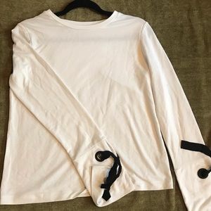 White shirt with black ribbon ties at cuffs